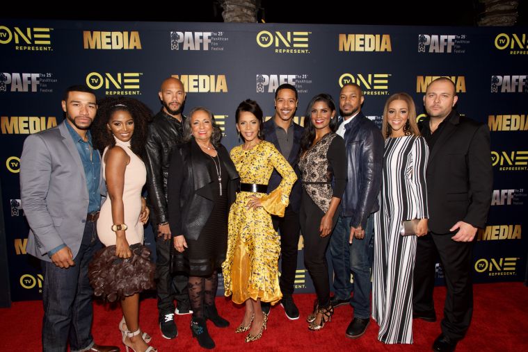 The cast of Media poses with Cathy Hughes