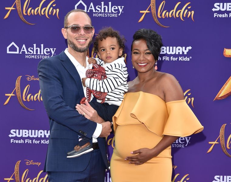 Tatyana Ali and her husband Vaughn Rasberry and their kids
