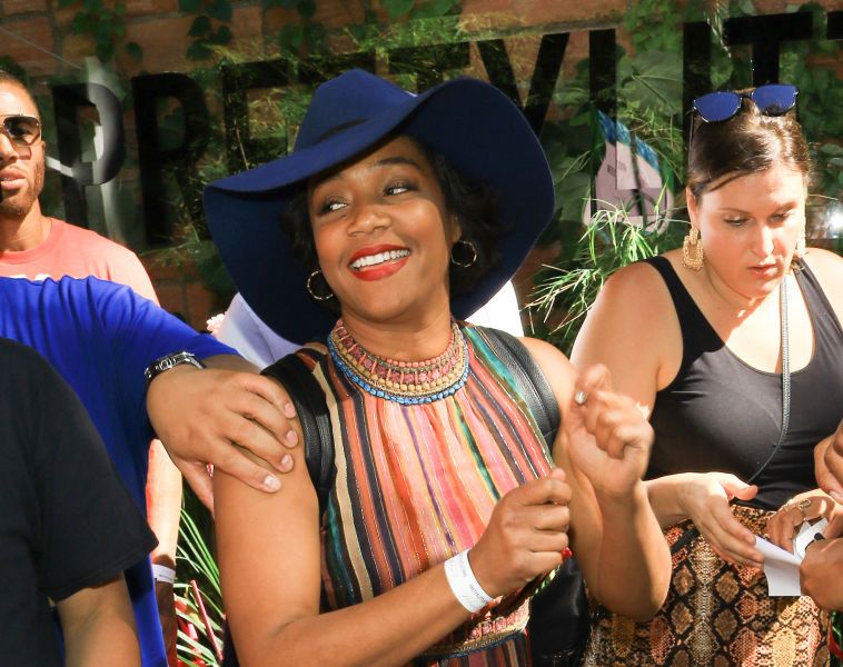 Tiffany Haddish Rocking A Wide Hat And Festive Dress
